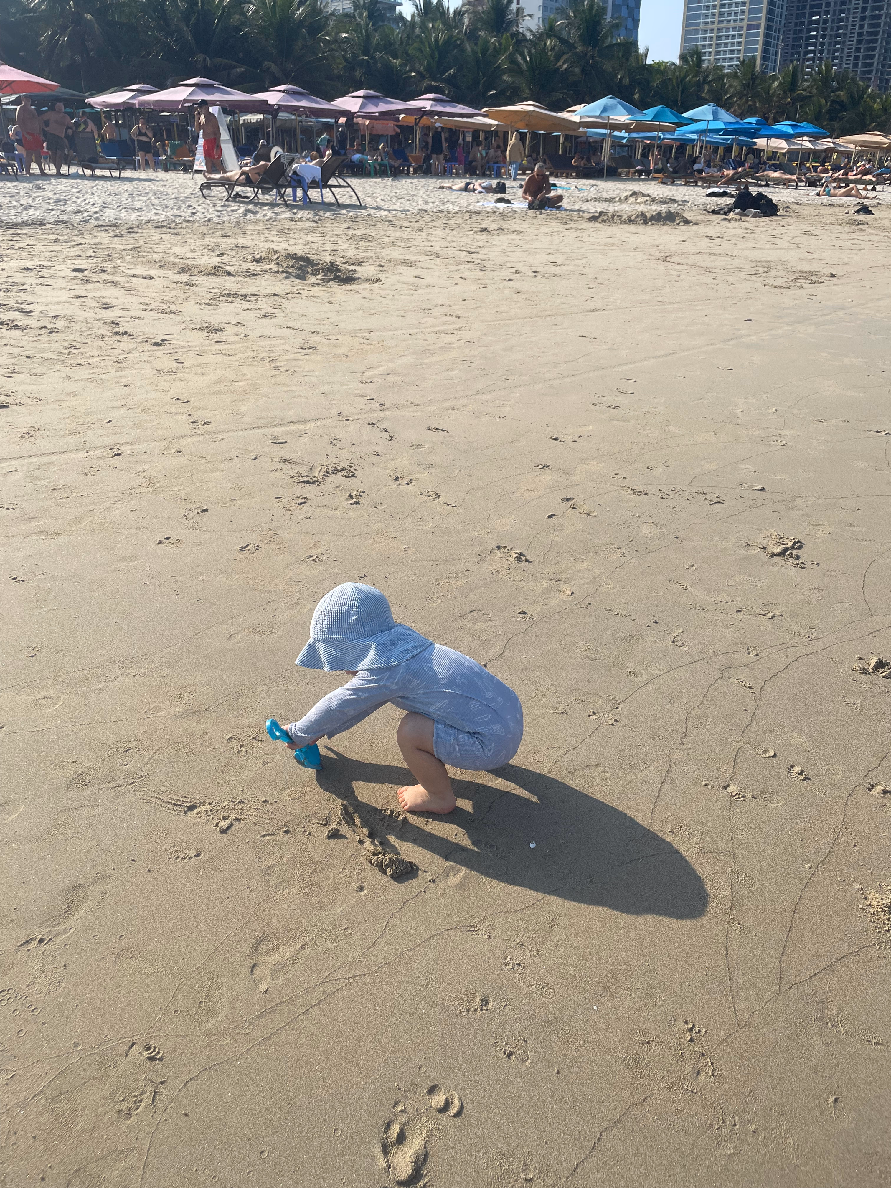 Toddler playing in the sand on Da Nang beach.