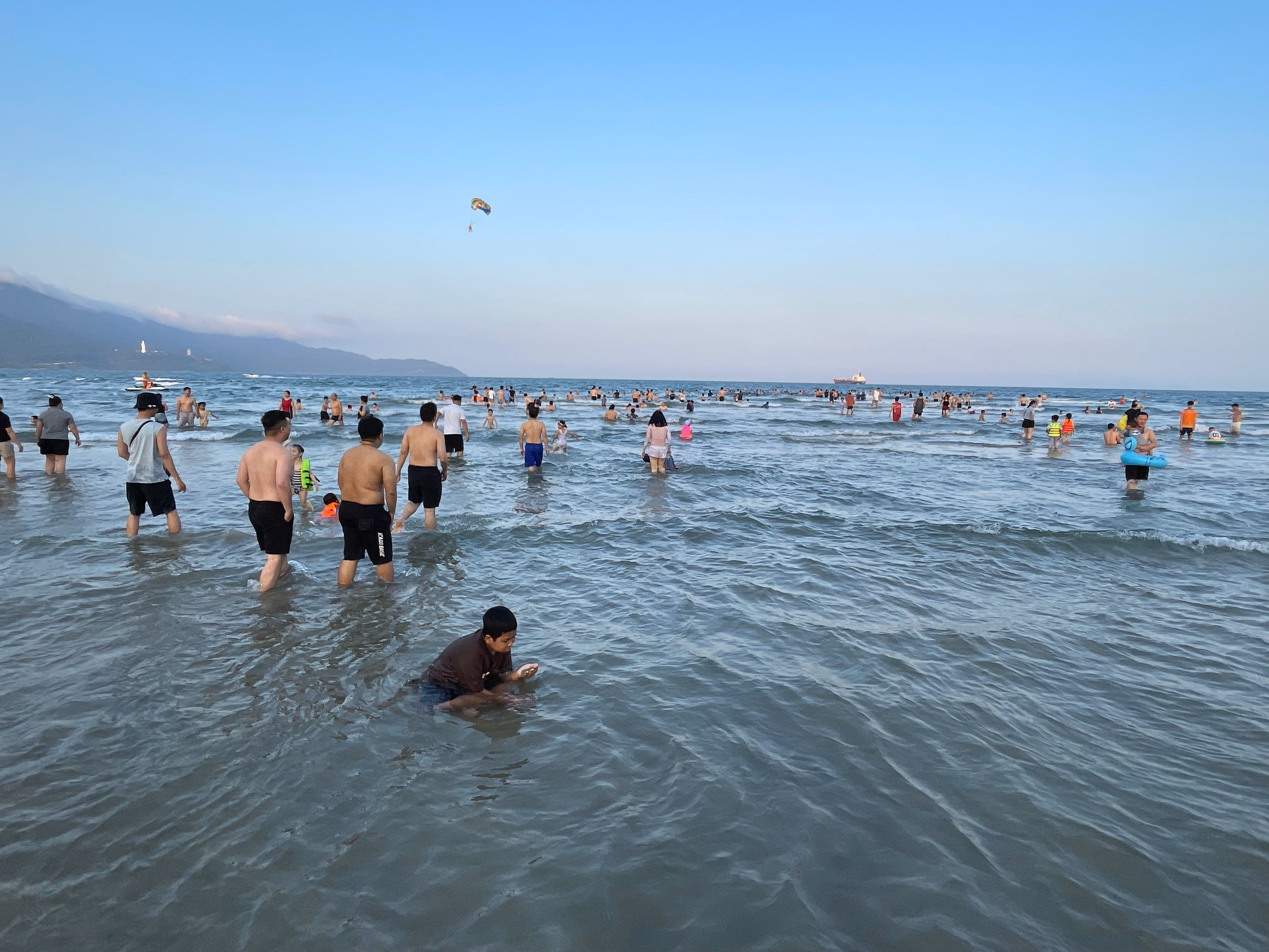Crowds enjoying the shallow water at Da Nang beach.