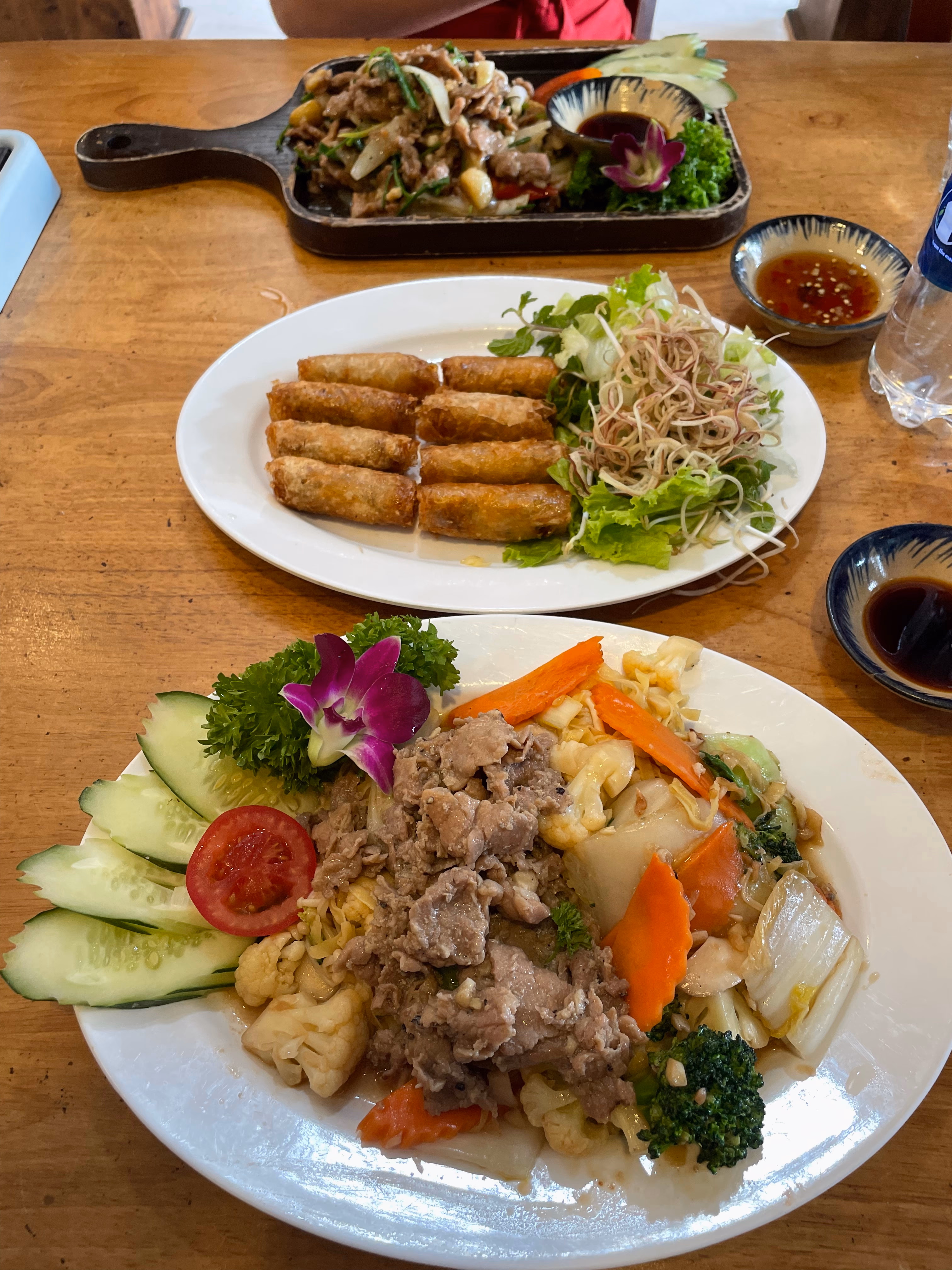 Fried spring rolls and stir-fried dishes at a Da Nang restaurant.