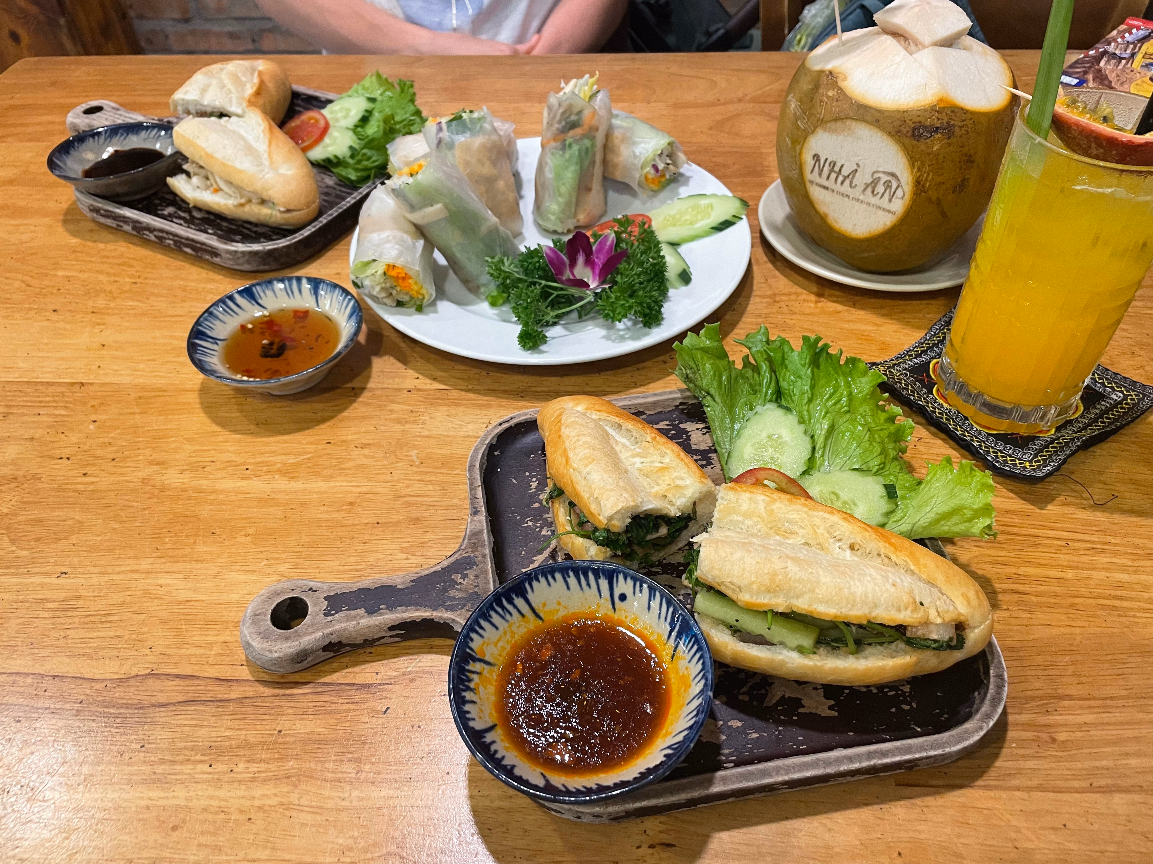Bánh mì, fresh spring rolls, and coconut water at a Da Nang restaurant.