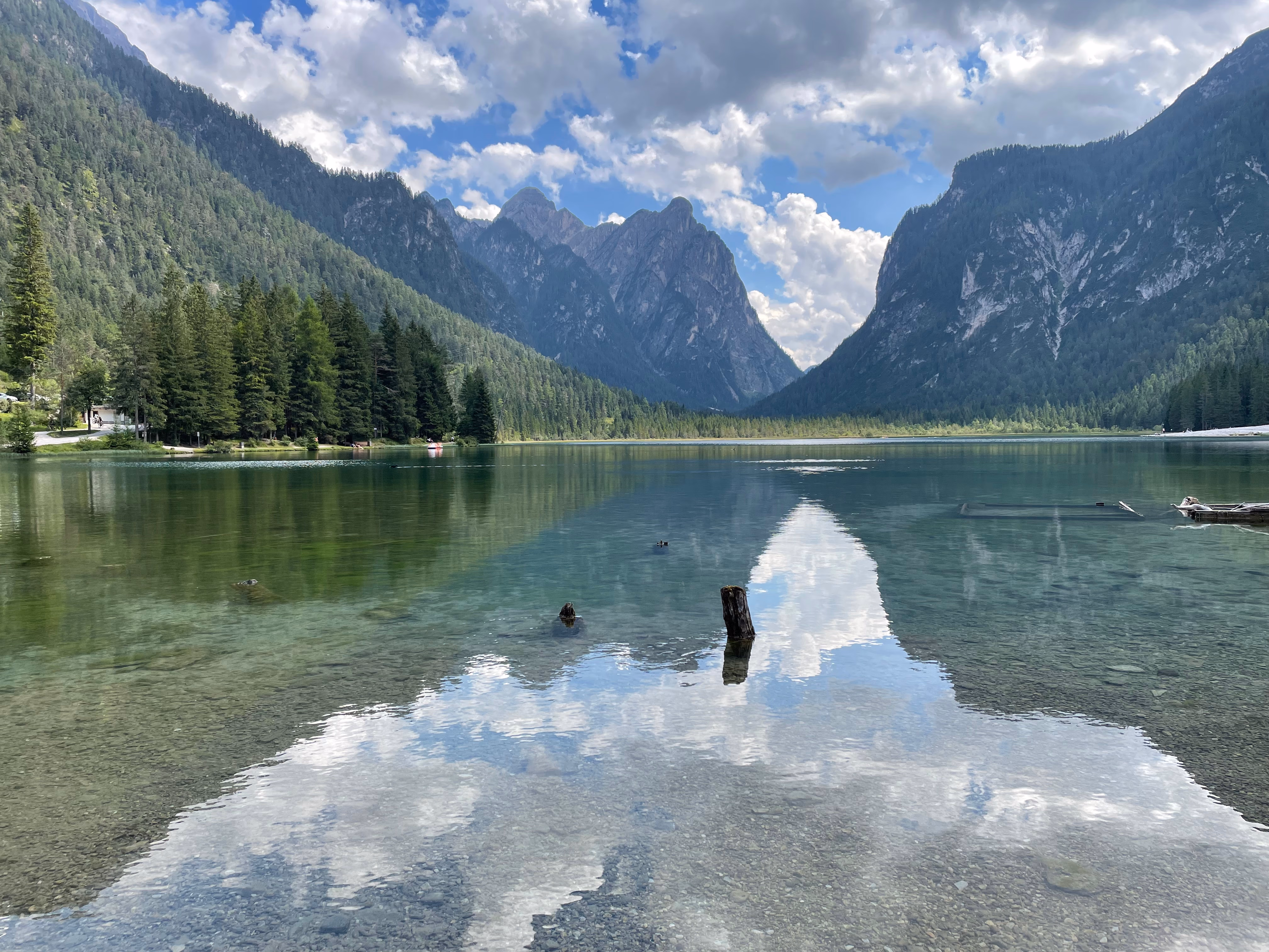 Distant mountains reflecting in the peaceful surface of Lago di Dobbiaco