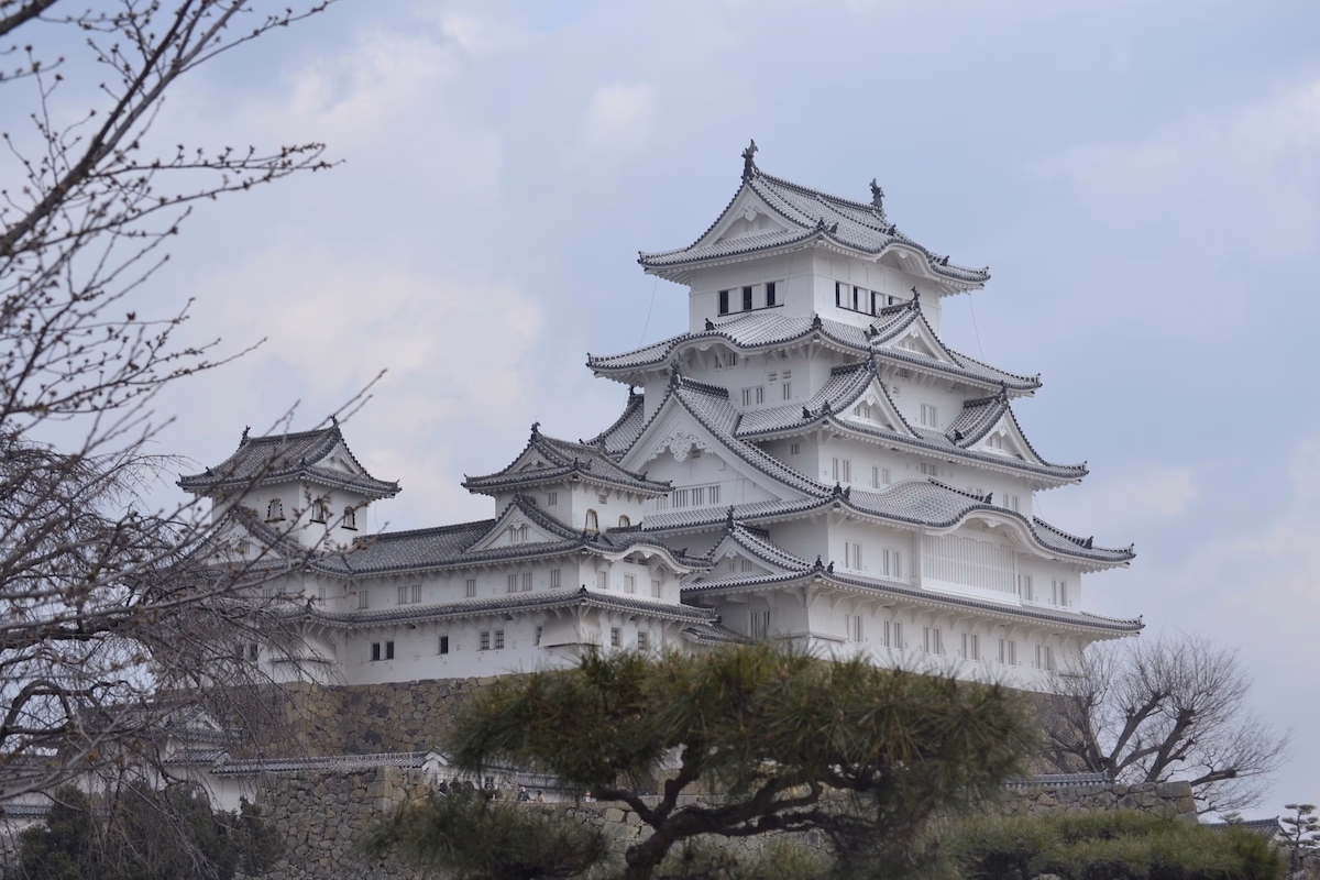 Japanese style white castle, rising in the middle of a park