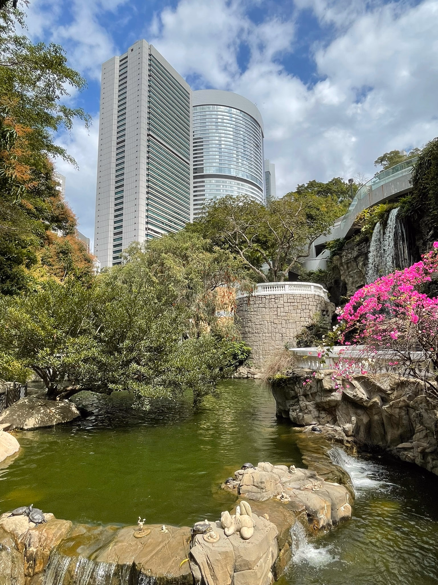 Hong Kong Park surrounded by skyscrapers.