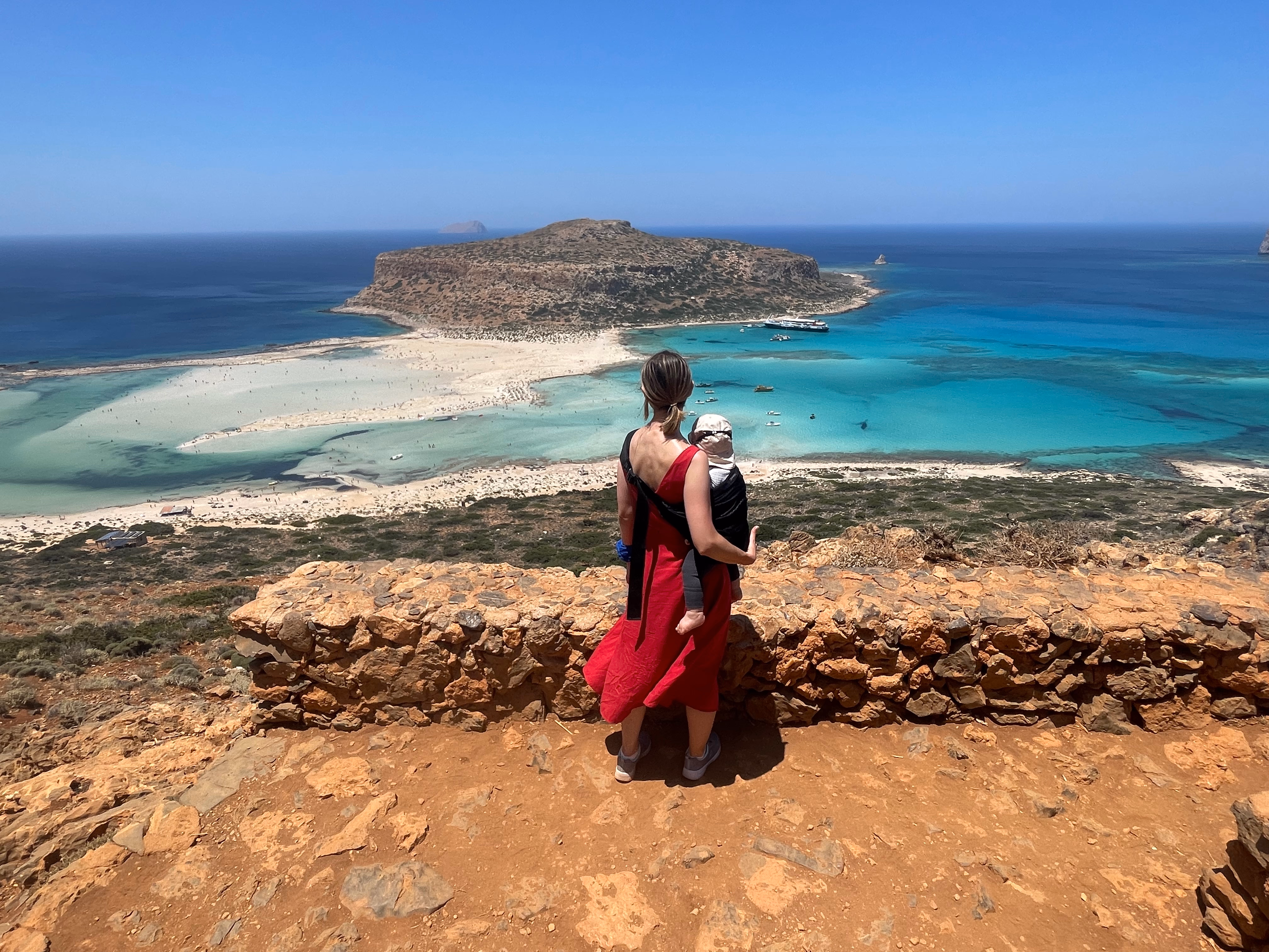 Mela carrying Edi overlooking a coastal lagoon
