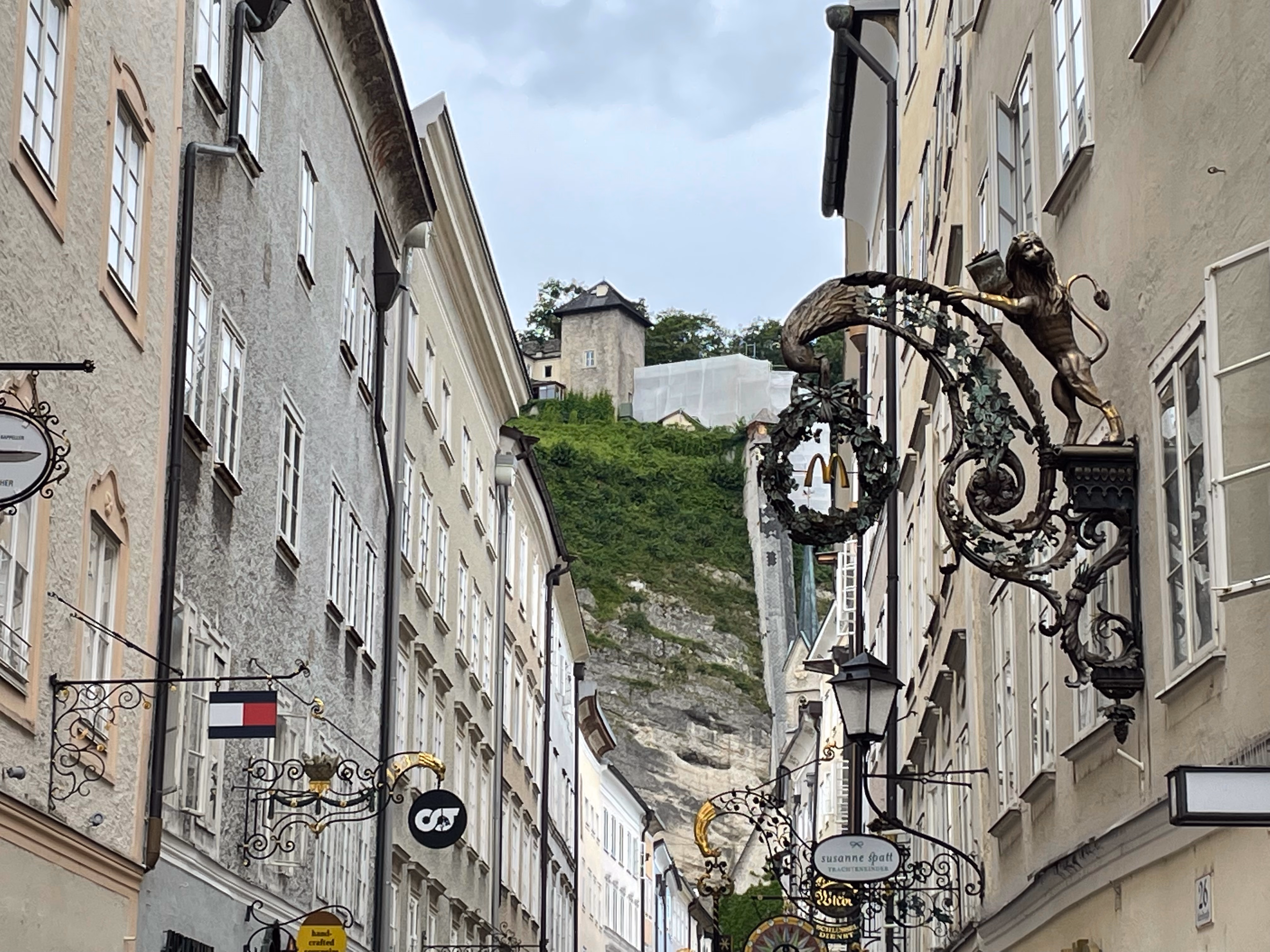 Store signs of modern brands done in a traditional style on Getreidegasse